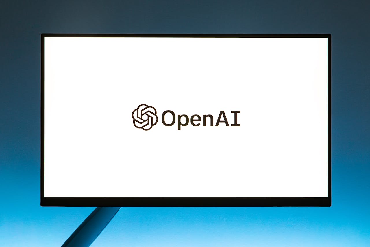 services-02 Minimalistic display of OpenAI logo on a monitor with a gradient blue background, representing modern technology.
