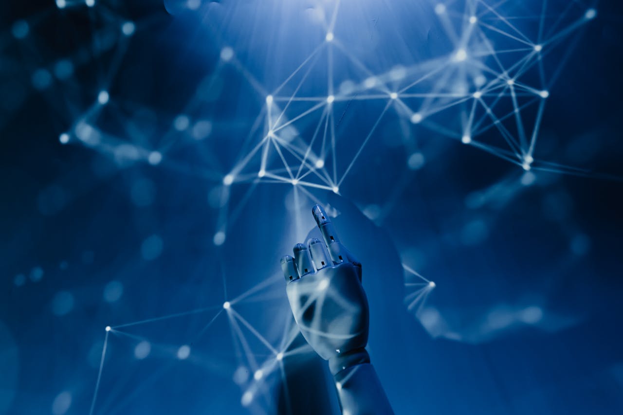 why-choose-us A robotic hand reaching into a digital network on a blue background, symbolizing AI technology.
